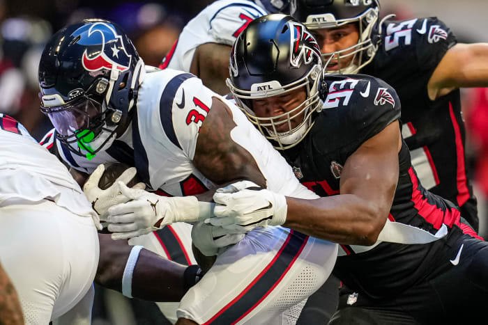 Atlanta Falcons defensive tackle Calais Campbell (93) tackles Houston Texans running back Dameon Pierce (31) during the first quarter at Mercedes-Benz Stadium.